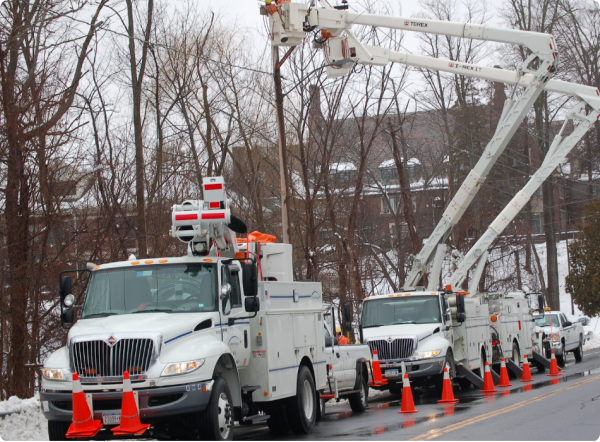 White bucket trucks and linemen